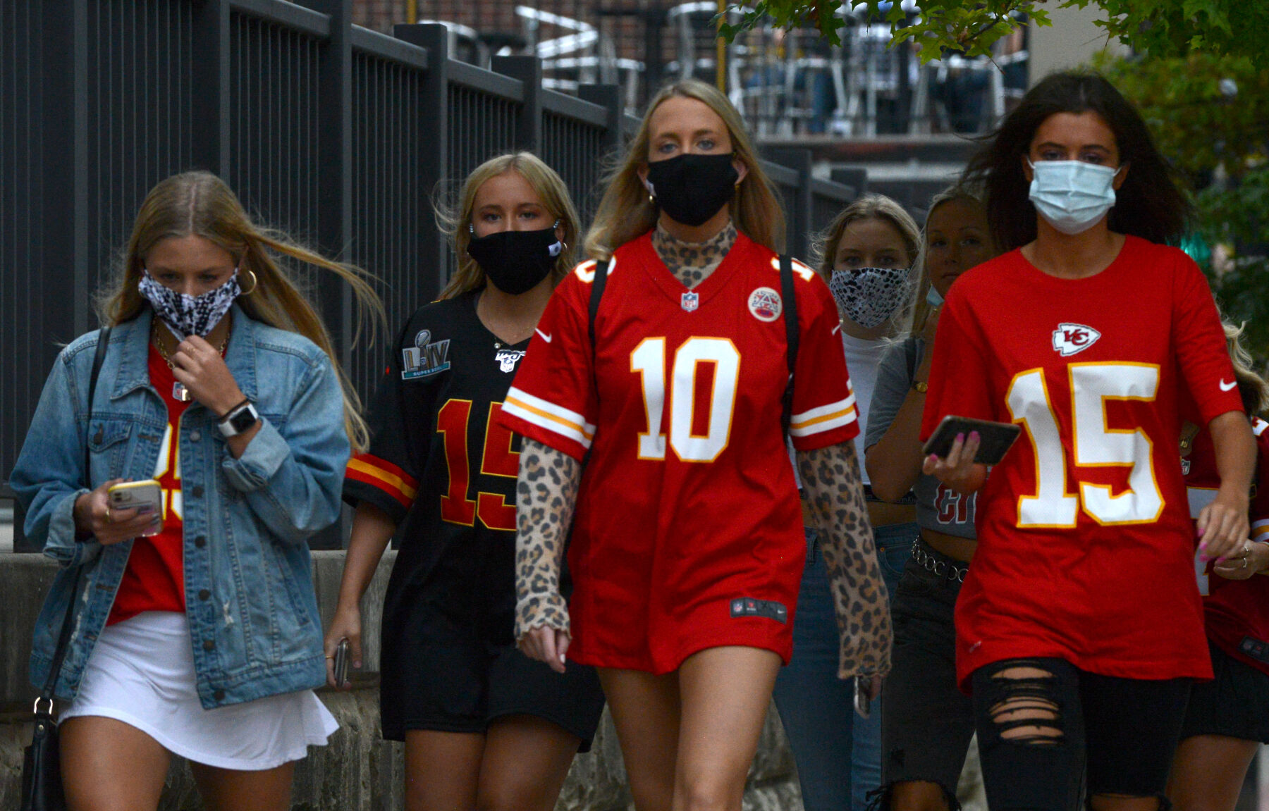 A group of young adults walks down Ninth Street